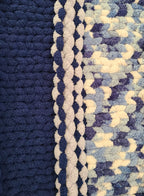 Winter Solstice — deep navy, light gray, and cream — close-up of the navy border against the mottled centre