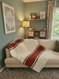 Autumn Ember — copper, coffee brown, and vintage white — draped over a cream sofa in the studio