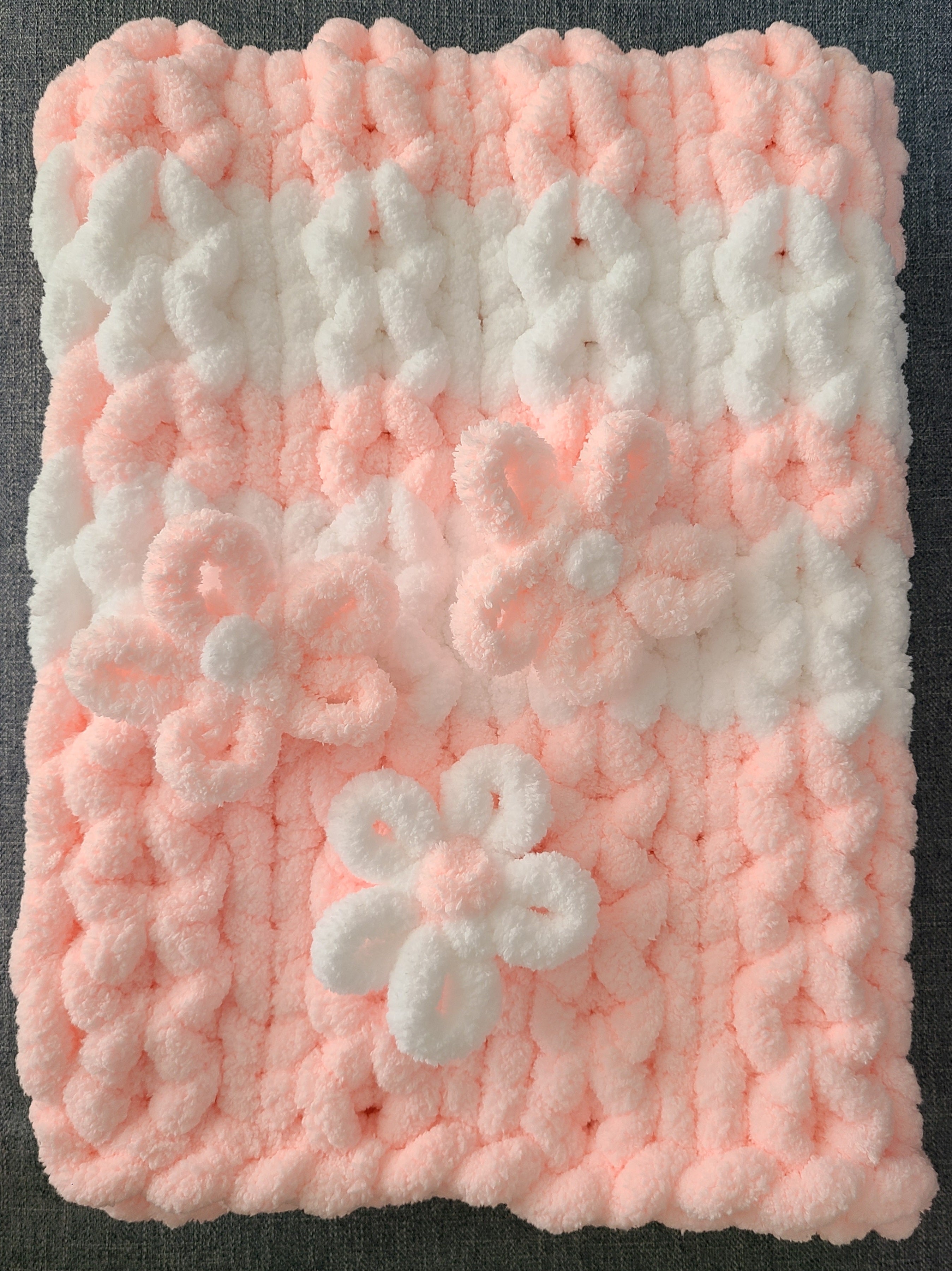 Blushing Mist baby blanket — white and soft pink — laid flat showing the diamond stitch and 3D flowers