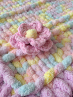 Lullaby Blossom baby blanket — pastel plaid with a lilac border — macro of the multi-petal crochet flower