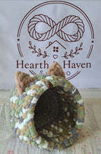 Snuggle Pod in Meadow Green — sage, cream and grey chenille — angled view showing the domed entrance