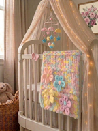 Wildflower Whisper baby blanket — pastel macaron tones — draped over a white crib rail in a soft nursery