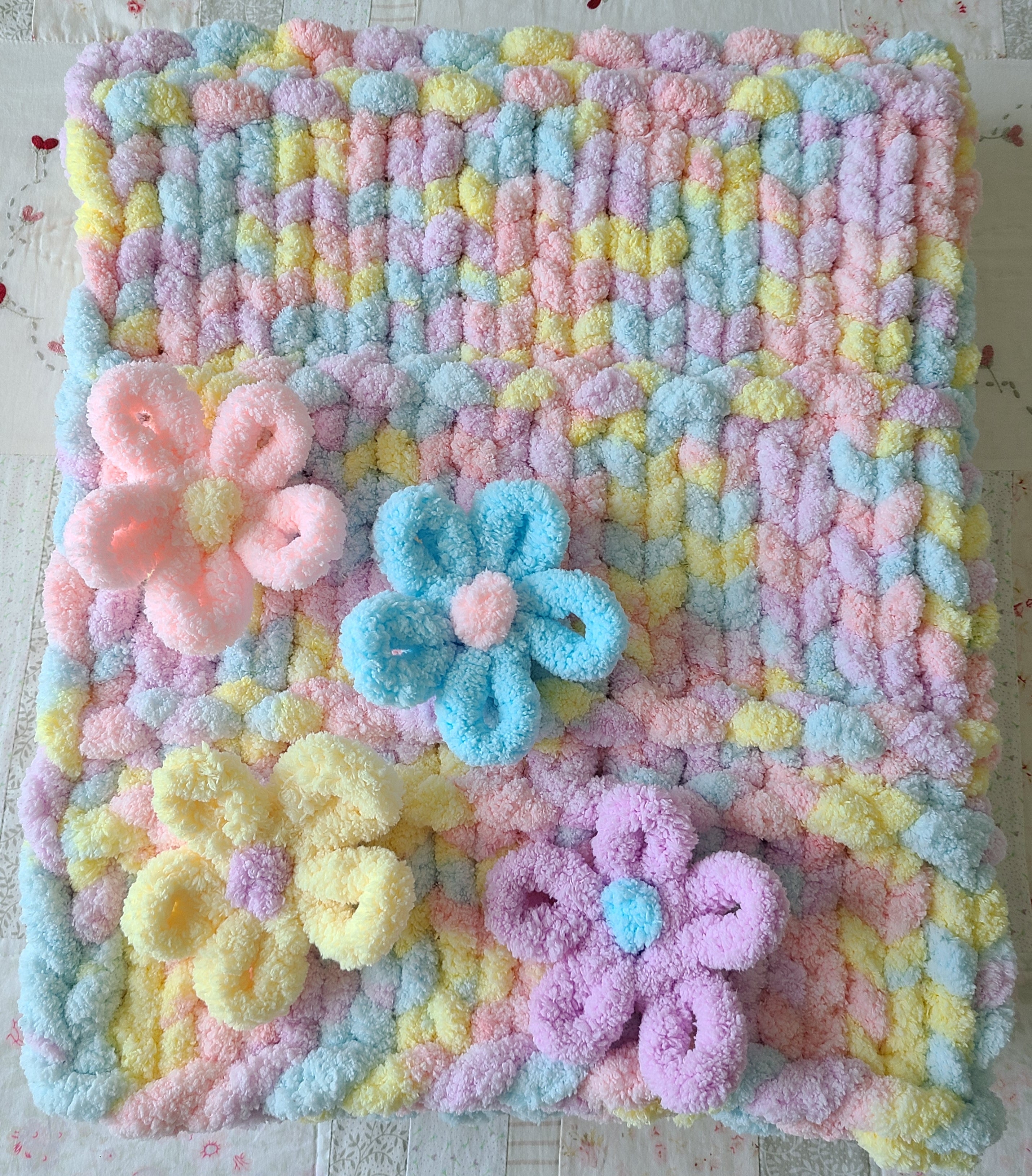 Wildflower Whisper baby blanket — pastel macaron tones — laid flat showing the full pattern and blooms