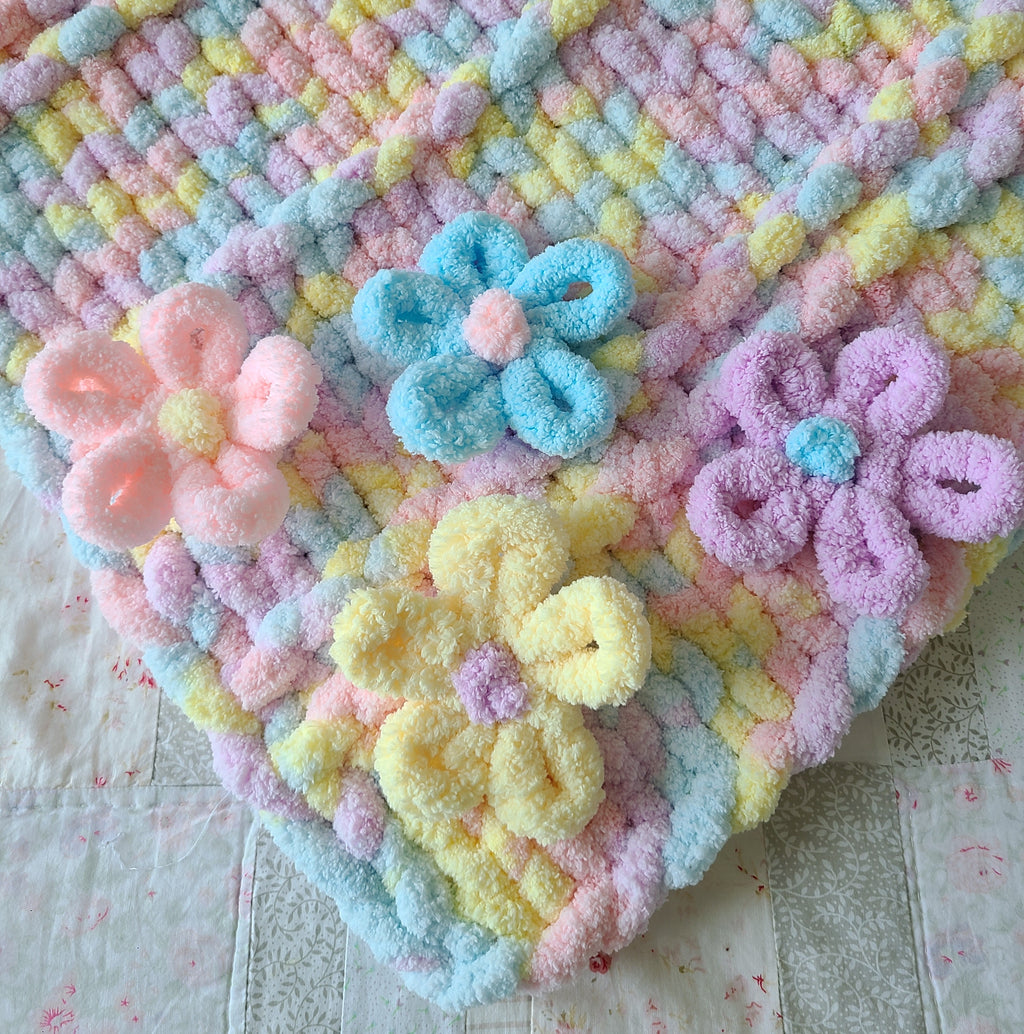 Wildflower Whisper baby blanket — pastel macaron tones — close-up of the 3D flower cluster and raised ridges
